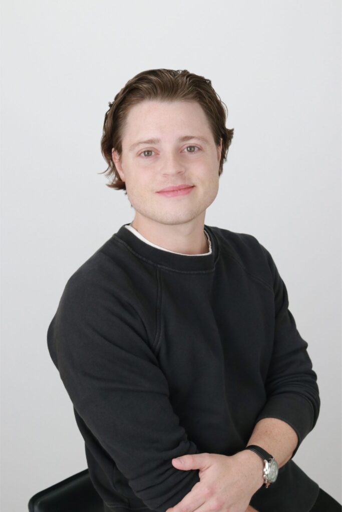 Professional headshot of Andy Sommer in a black sweater.